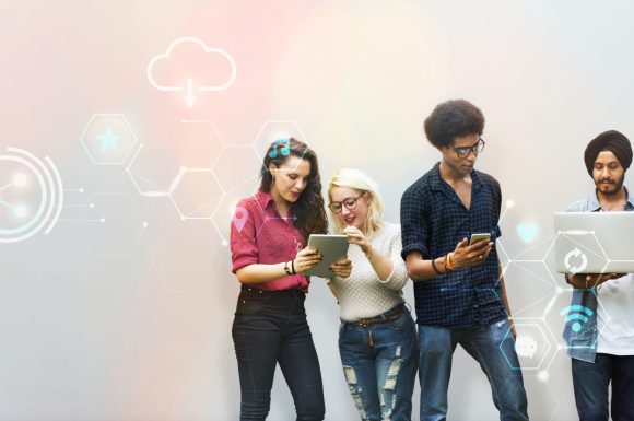 Diverse friends using digital devices